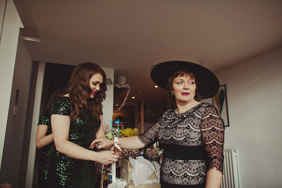 Gillian wore a colourful embroidered long sleeved gown by Temperley for her modern and alternative Woodside Warehouse wedding in Glasgow. Photography by Dan O'Day.