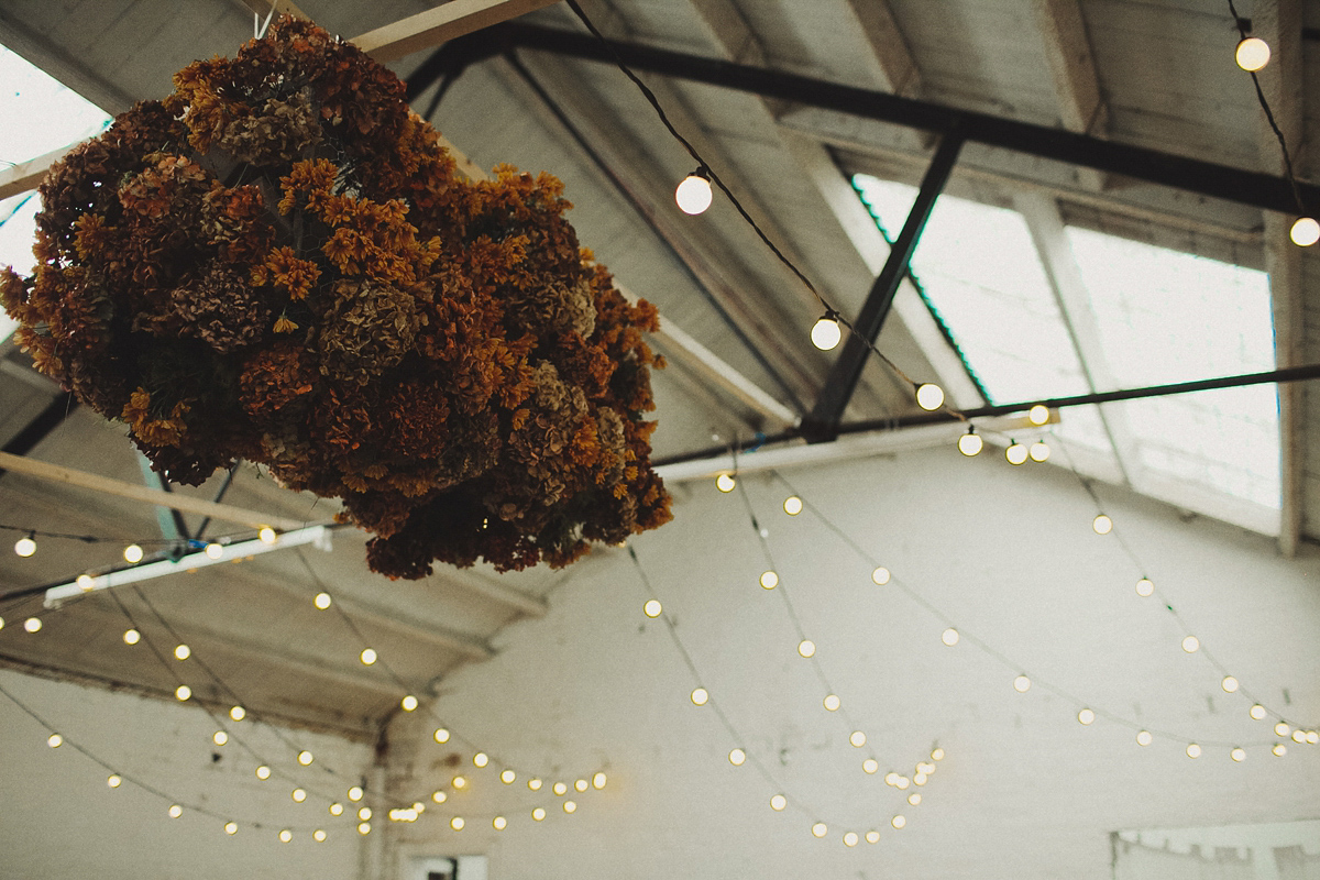 Gillian wore a colourful embroidered long sleeved gown by Temperley for her modern and alternative Woodside Warehouse wedding in Glasgow. Photography by Dan O'Day.