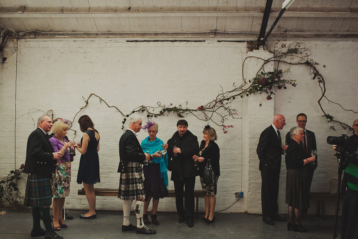 Gillian wore a colourful embroidered long sleeved gown by Temperley for her modern and alternative Woodside Warehouse wedding in Glasgow. Photography by Dan O'Day.