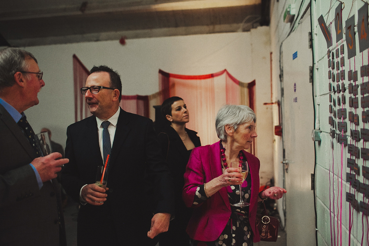 Gillian wore a colourful embroidered long sleeved gown by Temperley for her modern and alternative Woodside Warehouse wedding in Glasgow. Photography by Dan O'Day.