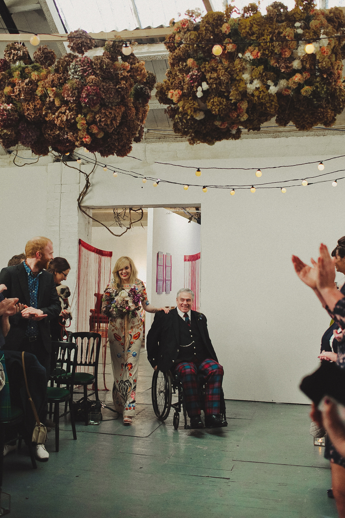 Gillian wore a colourful embroidered long sleeved gown by Temperley for her modern and alternative Woodside Warehouse wedding in Glasgow. Photography by Dan O'Day.