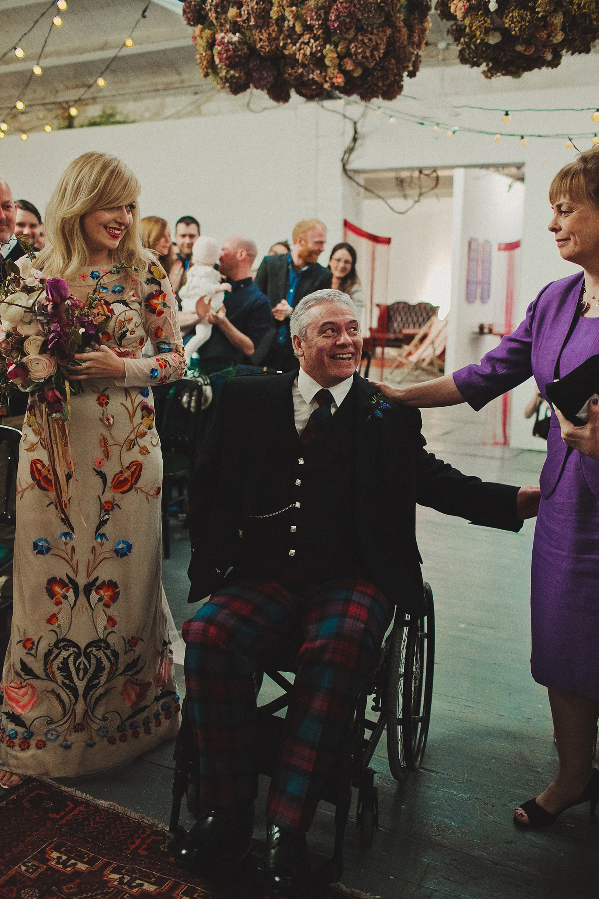 Gillian wore a colourful embroidered long sleeved gown by Temperley for her modern and alternative Woodside Warehouse wedding in Glasgow. Photography by Dan O'Day.