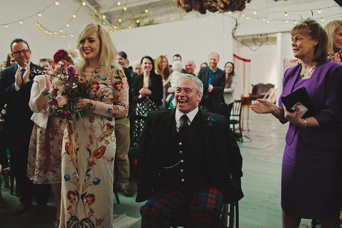 Gillian wore a colourful embroidered long sleeved gown by Temperley for her modern and alternative Woodside Warehouse wedding in Glasgow. Photography by Dan O'Day.