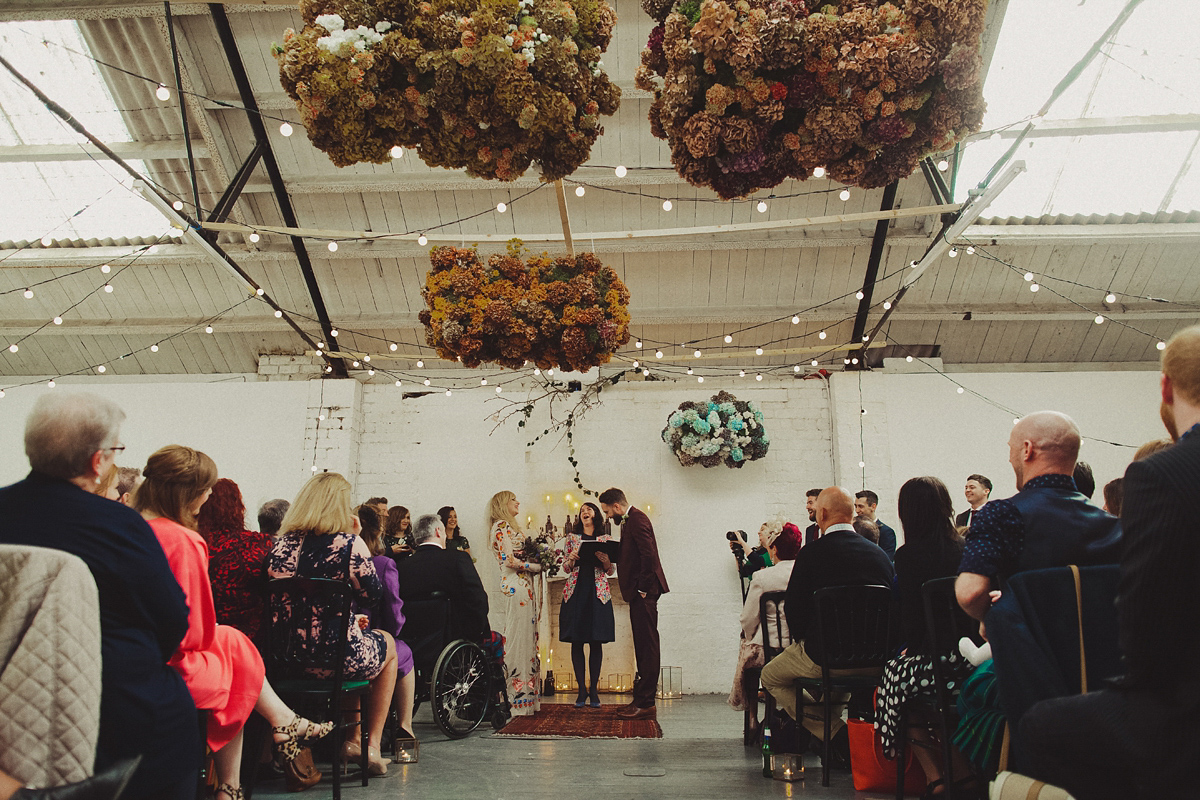 Gillian wore a colourful embroidered long sleeved gown by Temperley for her modern and alternative Woodside Warehouse wedding in Glasgow. Photography by Dan O'Day.