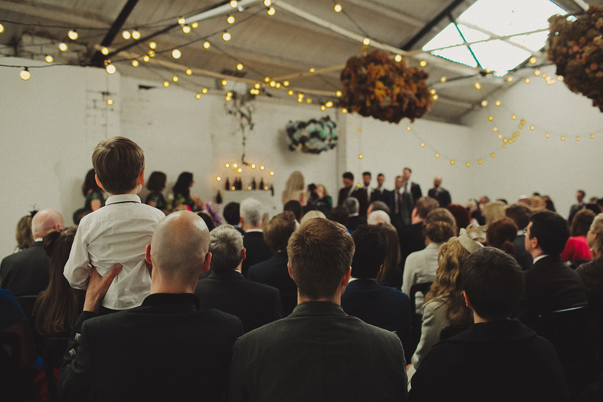 Gillian wore a colourful embroidered long sleeved gown by Temperley for her modern and alternative Woodside Warehouse wedding in Glasgow. Photography by Dan O'Day.