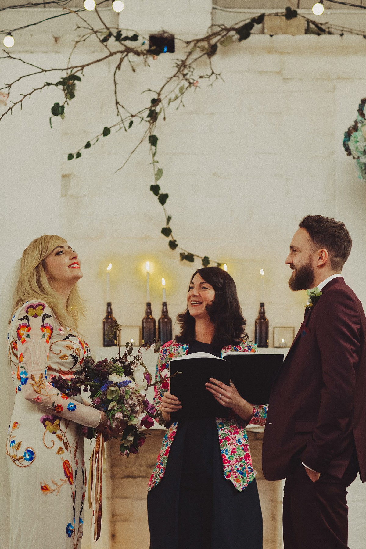 Gillian wore a colourful embroidered long sleeved gown by Temperley for her modern and alternative Woodside Warehouse wedding in Glasgow. Photography by Dan O'Day.