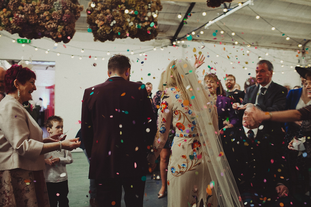 Gillian wore a colourful embroidered long sleeved gown by Temperley for her modern and alternative Woodside Warehouse wedding in Glasgow. Photography by Dan O'Day.