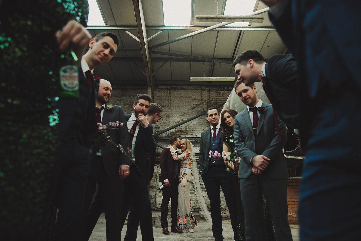 Gillian wore a colourful embroidered long sleeved gown by Temperley for her modern and alternative Woodside Warehouse wedding in Glasgow. Photography by Dan O'Day.