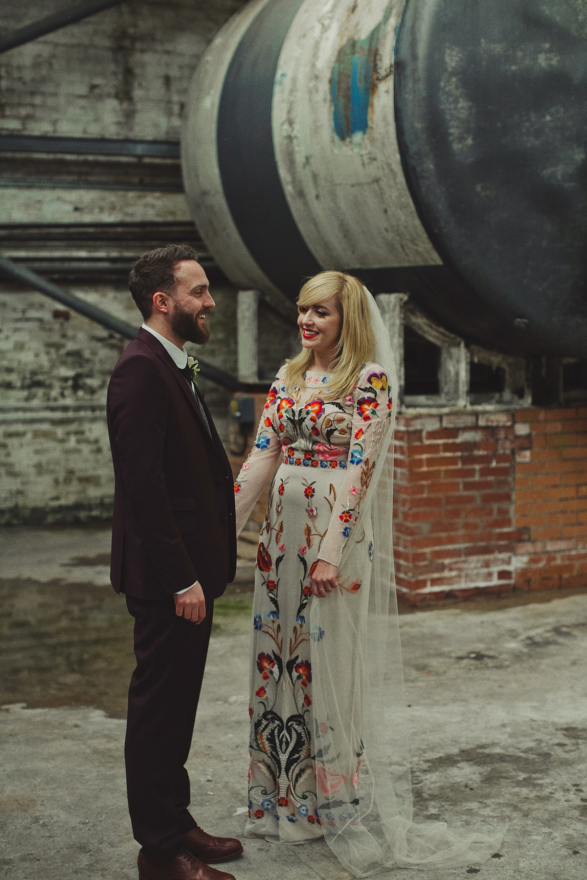 Gillian wore a colourful embroidered long sleeved gown by Temperley for her modern and alternative Woodside Warehouse wedding in Glasgow. Photography by Dan O'Day.