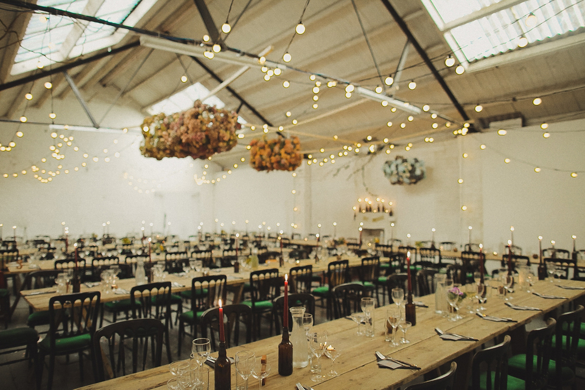 Gillian wore a colourful embroidered long sleeved gown by Temperley for her modern and alternative Woodside Warehouse wedding in Glasgow. Photography by Dan O'Day.