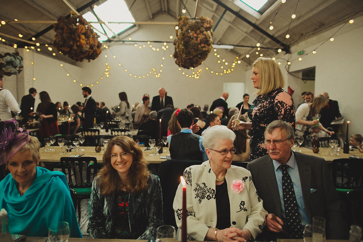 Gillian wore a colourful embroidered long sleeved gown by Temperley for her modern and alternative Woodside Warehouse wedding in Glasgow. Photography by Dan O'Day.