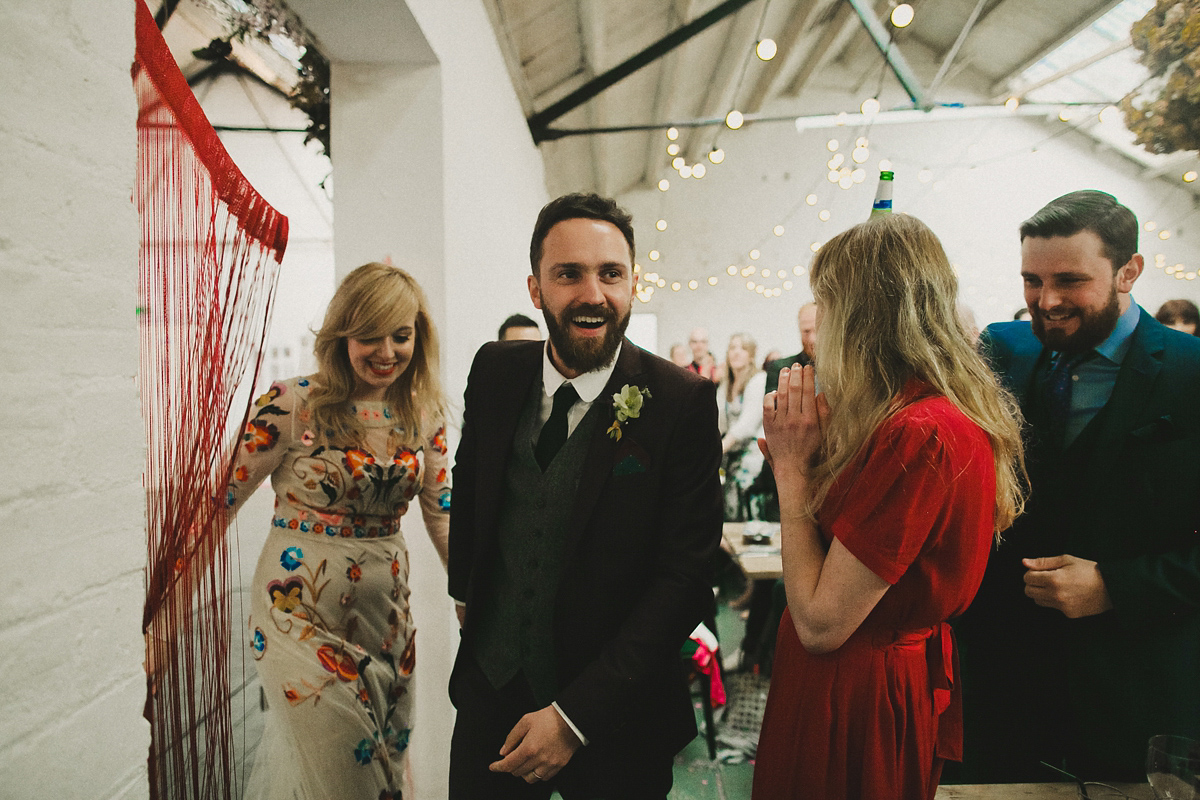 Gillian wore a colourful embroidered long sleeved gown by Temperley for her modern and alternative Woodside Warehouse wedding in Glasgow. Photography by Dan O'Day.