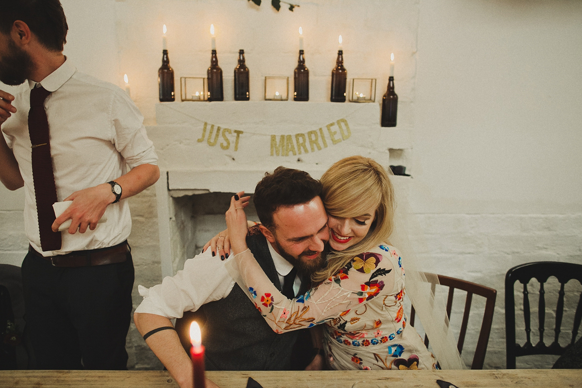 Gillian wore a colourful embroidered long sleeved gown by Temperley for her modern and alternative Woodside Warehouse wedding in Glasgow. Photography by Dan O'Day.