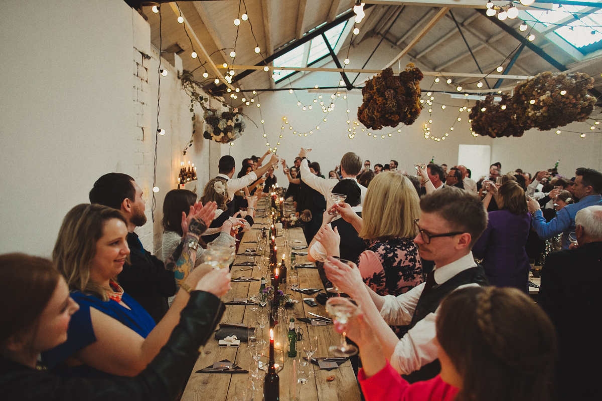 Gillian wore a colourful embroidered long sleeved gown by Temperley for her modern and alternative Woodside Warehouse wedding in Glasgow. Photography by Dan O'Day.