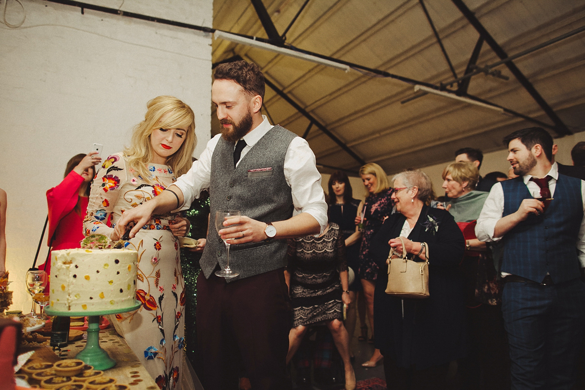 Gillian wore a colourful embroidered long sleeved gown by Temperley for her modern and alternative Woodside Warehouse wedding in Glasgow. Photography by Dan O'Day.