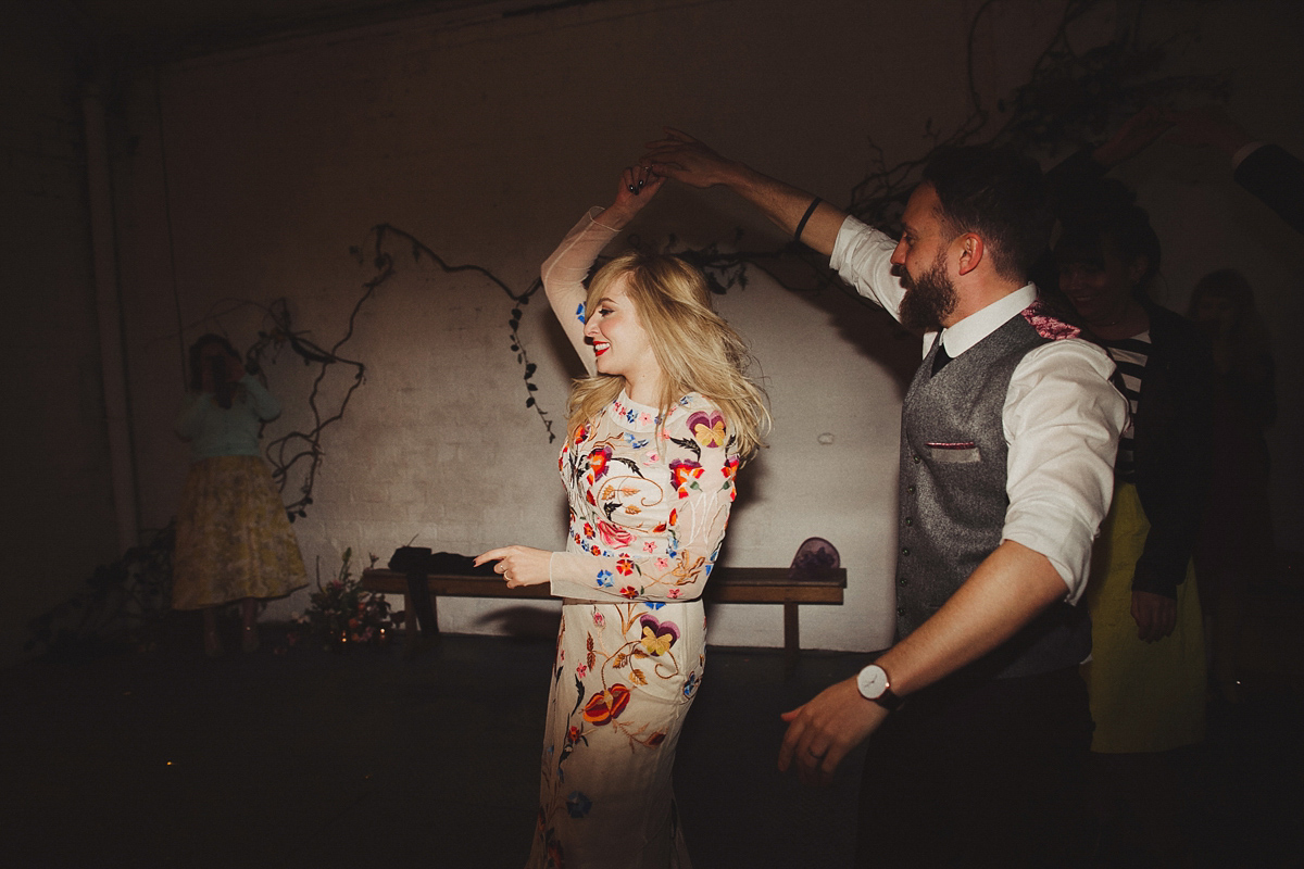 Gillian wore a colourful embroidered long sleeved gown by Temperley for her modern and alternative Woodside Warehouse wedding in Glasgow. Photography by Dan O'Day.