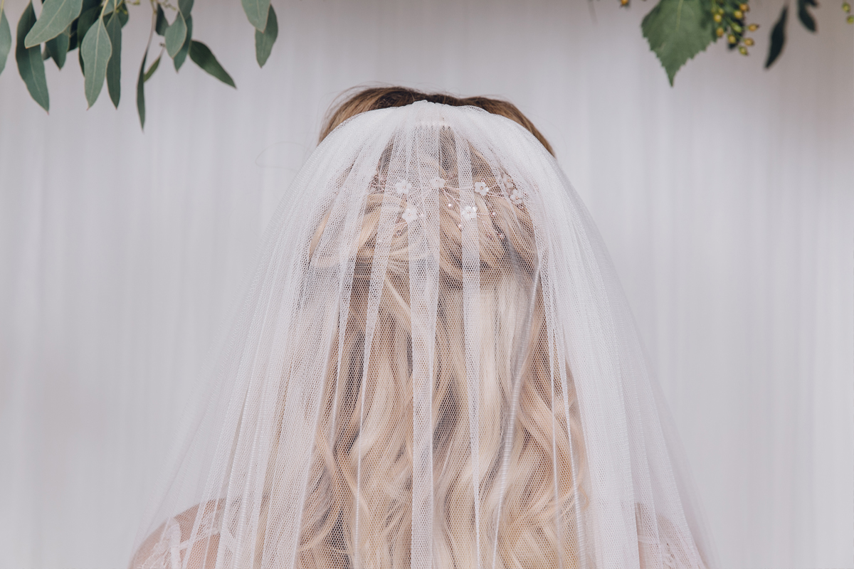 The Evie hair vine worn under a long veil, by Debbie Carlisle