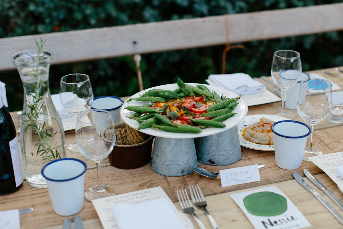 Rosa wore a boho dress by eco-bridal fashion label Minna for her vegetarian feast, secret herb garden wedding. Photography by Caro Weiss.