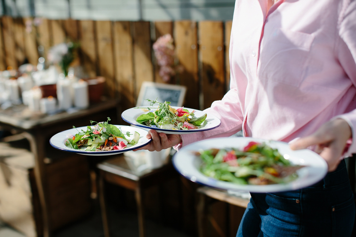 Rosa wore a boho dress by eco-bridal fashion label Minna for her vegetarian feast, secret herb garden wedding. Photography by Caro Weiss.