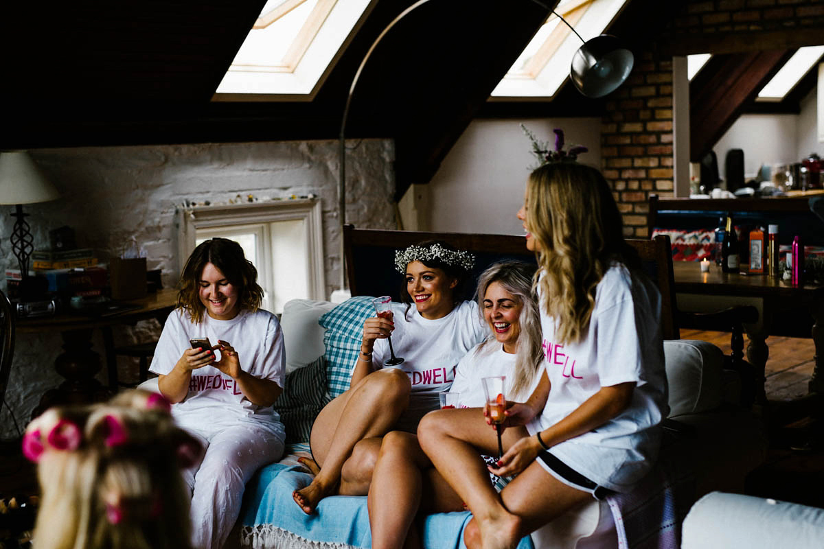 Kirsty wore a Rue de Seine gown from Leonie C. Bridal boutique in Brighton. Her handmade, Summer wedding took place in a Game of Thrones venue in Downpatrick. It was filled with floral chandeliers. Photography by Honey and the Moon.