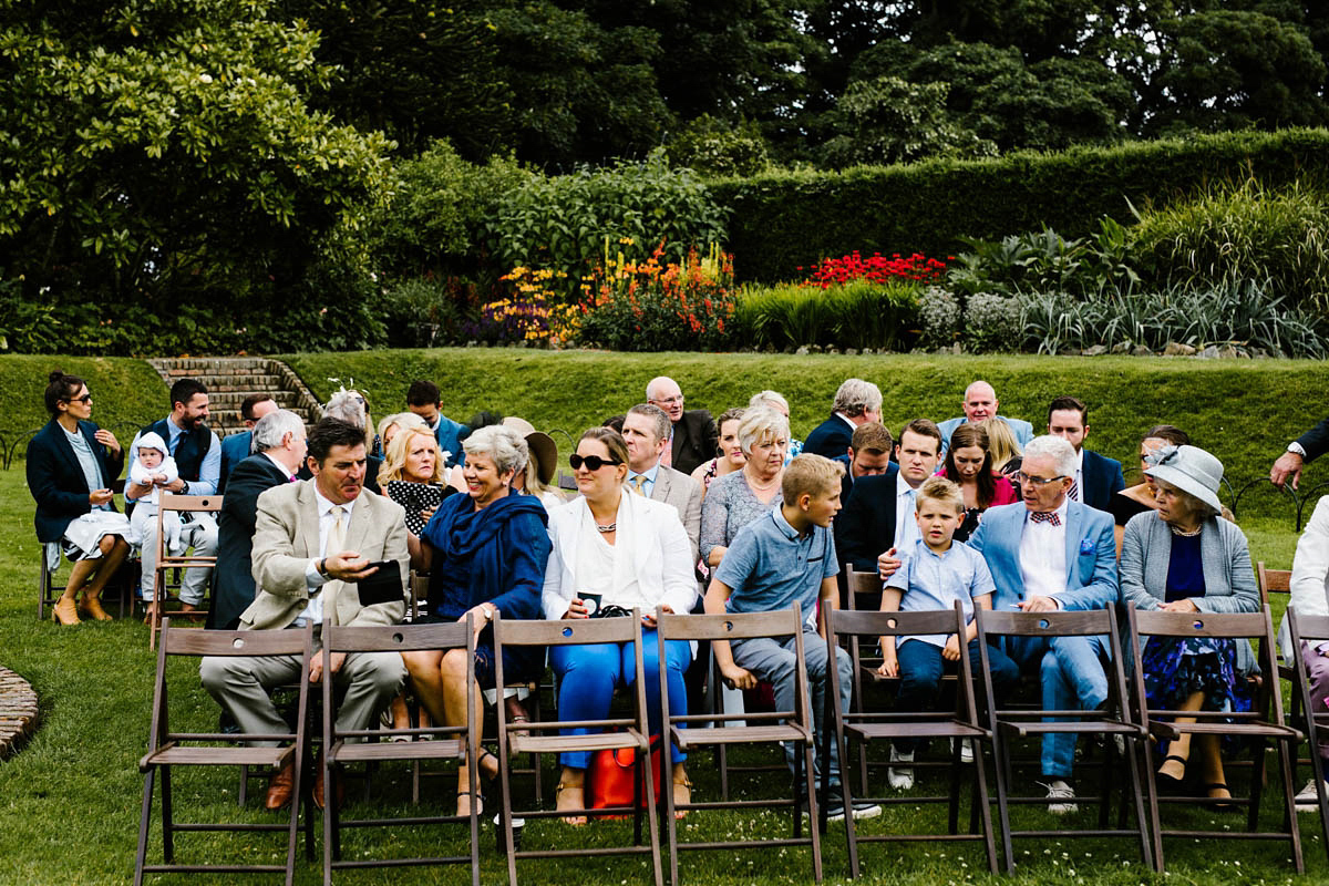 Kirsty wore a Rue de Seine gown from Leonie C. Bridal boutique in Brighton. Her handmade, Summer wedding took place in a Game of Thrones venue in Downpatrick. It was filled with floral chandeliers. Photography by Honey and the Moon.