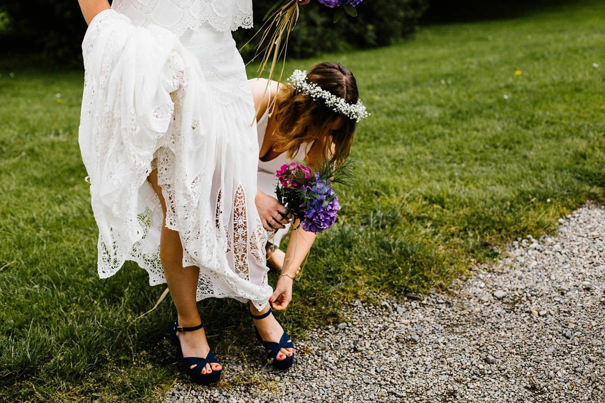 Kirsty wore a Rue de Seine gown from Leonie C. Bridal boutique in Brighton. Her handmade, Summer wedding took place in a Game of Thrones venue in Downpatrick. It was filled with floral chandeliers. Photography by Honey and the Moon.