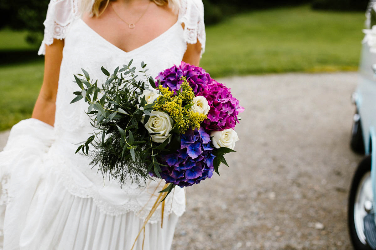 Kirsty wore a Rue de Seine gown from Leonie C. Bridal boutique in Brighton. Her handmade, Summer wedding took place in a Game of Thrones venue in Downpatrick. It was filled with floral chandeliers. Photography by Honey and the Moon.