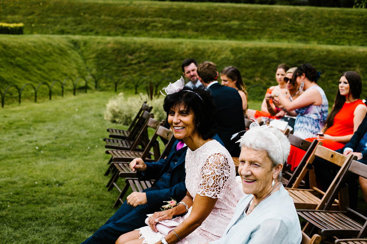 Kirsty wore a Rue de Seine gown from Leonie C. Bridal boutique in Brighton. Her handmade, Summer wedding took place in a Game of Thrones venue in Downpatrick. It was filled with floral chandeliers. Photography by Honey and the Moon.