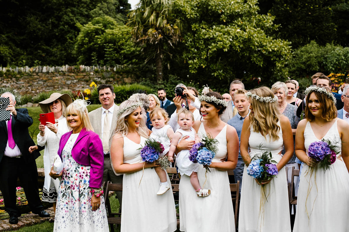 Kirsty wore a Rue de Seine gown from Leonie C. Bridal boutique in Brighton. Her handmade, Summer wedding took place in a Game of Thrones venue in Downpatrick. It was filled with floral chandeliers. Photography by Honey and the Moon.