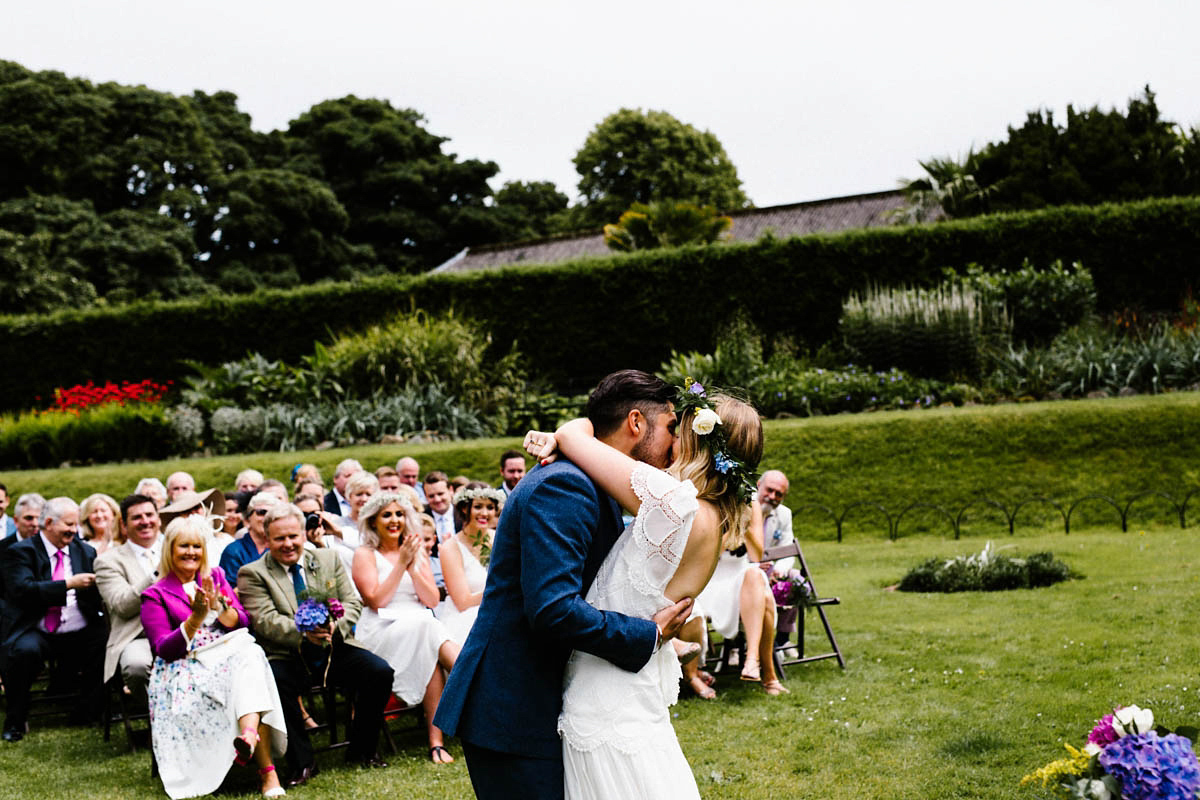 Kirsty wore a Rue de Seine gown from Leonie C. Bridal boutique in Brighton. Her handmade, Summer wedding took place in a Game of Thrones venue in Downpatrick. It was filled with floral chandeliers. Photography by Honey and the Moon.