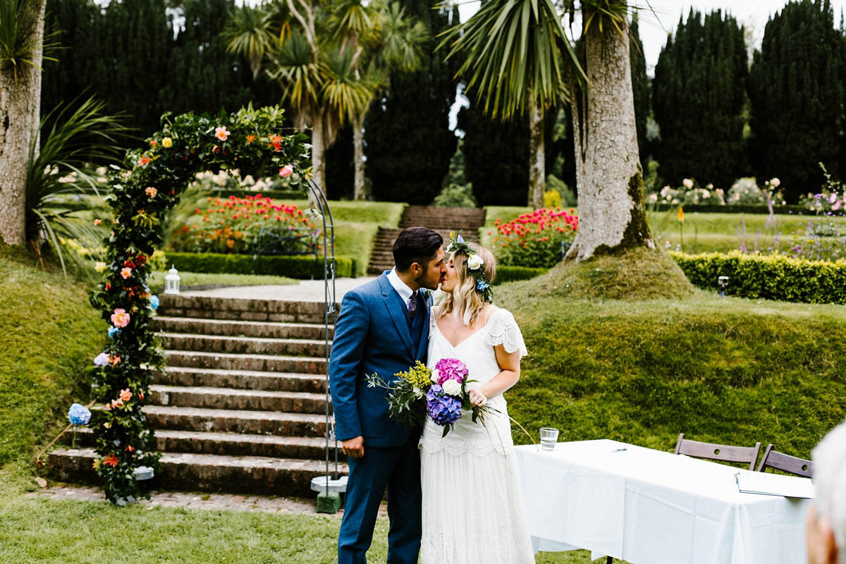 Kirsty wore a Rue de Seine gown from Leonie C. Bridal boutique in Brighton. Her handmade, Summer wedding took place in a Game of Thrones venue in Downpatrick. It was filled with floral chandeliers. Photography by Honey and the Moon.