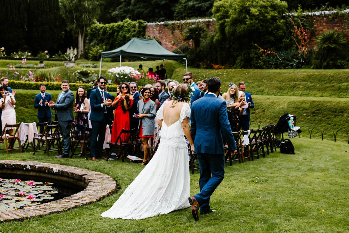 Kirsty wore a Rue de Seine gown from Leonie C. Bridal boutique in Brighton. Her handmade, Summer wedding took place in a Game of Thrones venue in Downpatrick. It was filled with floral chandeliers. Photography by Honey and the Moon.