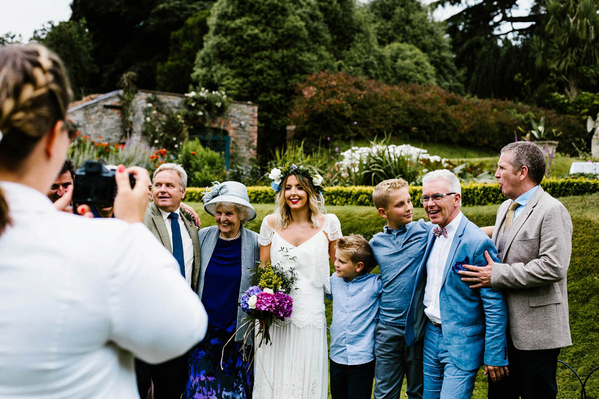 Kirsty wore a Rue de Seine gown from Leonie C. Bridal boutique in Brighton. Her handmade, Summer wedding took place in a Game of Thrones venue in Downpatrick. It was filled with floral chandeliers. Photography by Honey and the Moon.