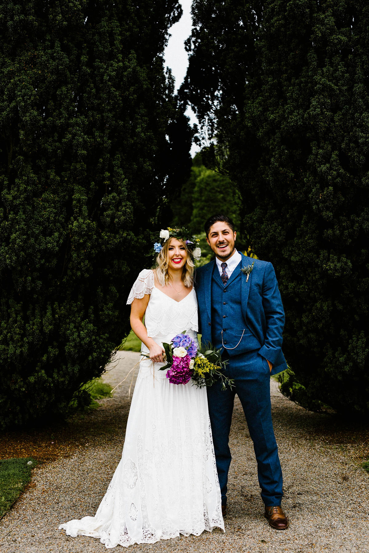 Kirsty wore a Rue de Seine gown from Leonie C. Bridal boutique in Brighton. Her handmade, Summer wedding took place in a Game of Thrones venue in Downpatrick. It was filled with floral chandeliers. Photography by Honey and the Moon.