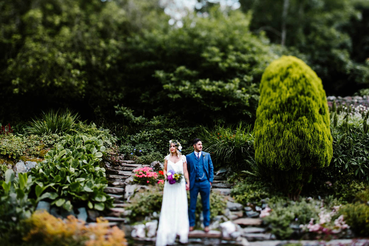 Kirsty wore a Rue de Seine gown from Leonie C. Bridal boutique in Brighton. Her handmade, Summer wedding took place in a Game of Thrones venue in Downpatrick. It was filled with floral chandeliers. Photography by Honey and the Moon.