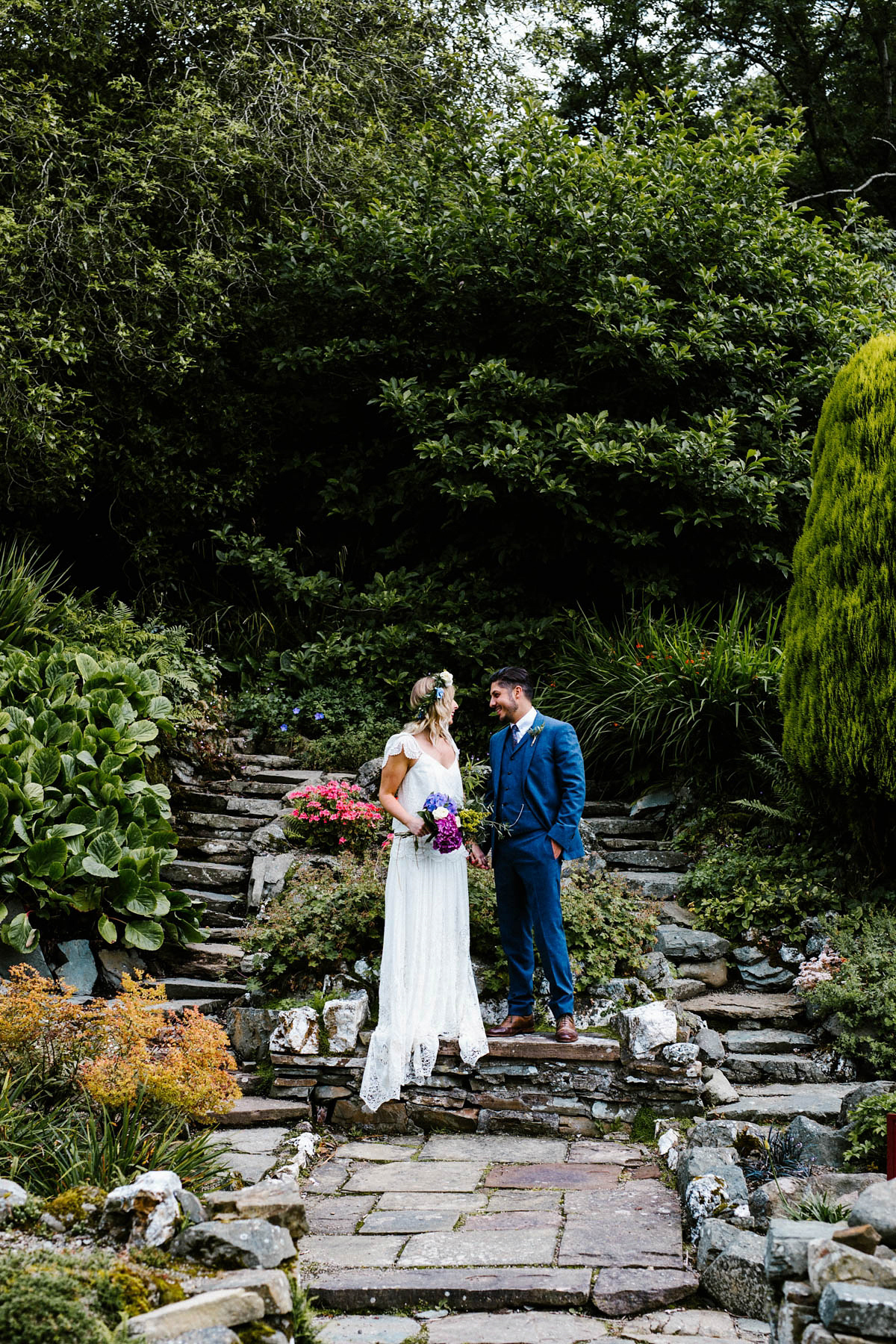 Kirsty wore a Rue de Seine gown from Leonie C. Bridal boutique in Brighton. Her handmade, Summer wedding took place in a Game of Thrones venue in Downpatrick. It was filled with floral chandeliers. Photography by Honey and the Moon.