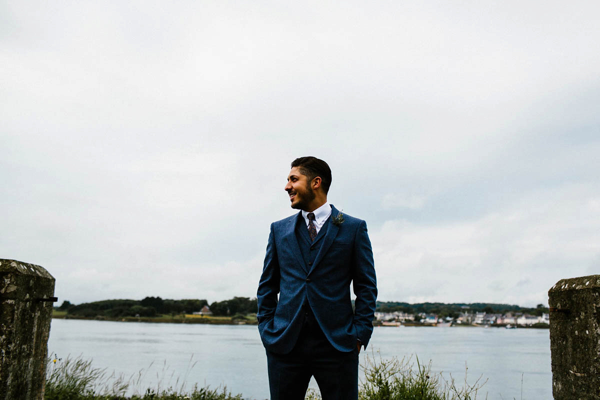 Kirsty wore a Rue de Seine gown from Leonie C. Bridal boutique in Brighton. Her handmade, Summer wedding took place in a Game of Thrones venue in Downpatrick. It was filled with floral chandeliers. Photography by Honey and the Moon.