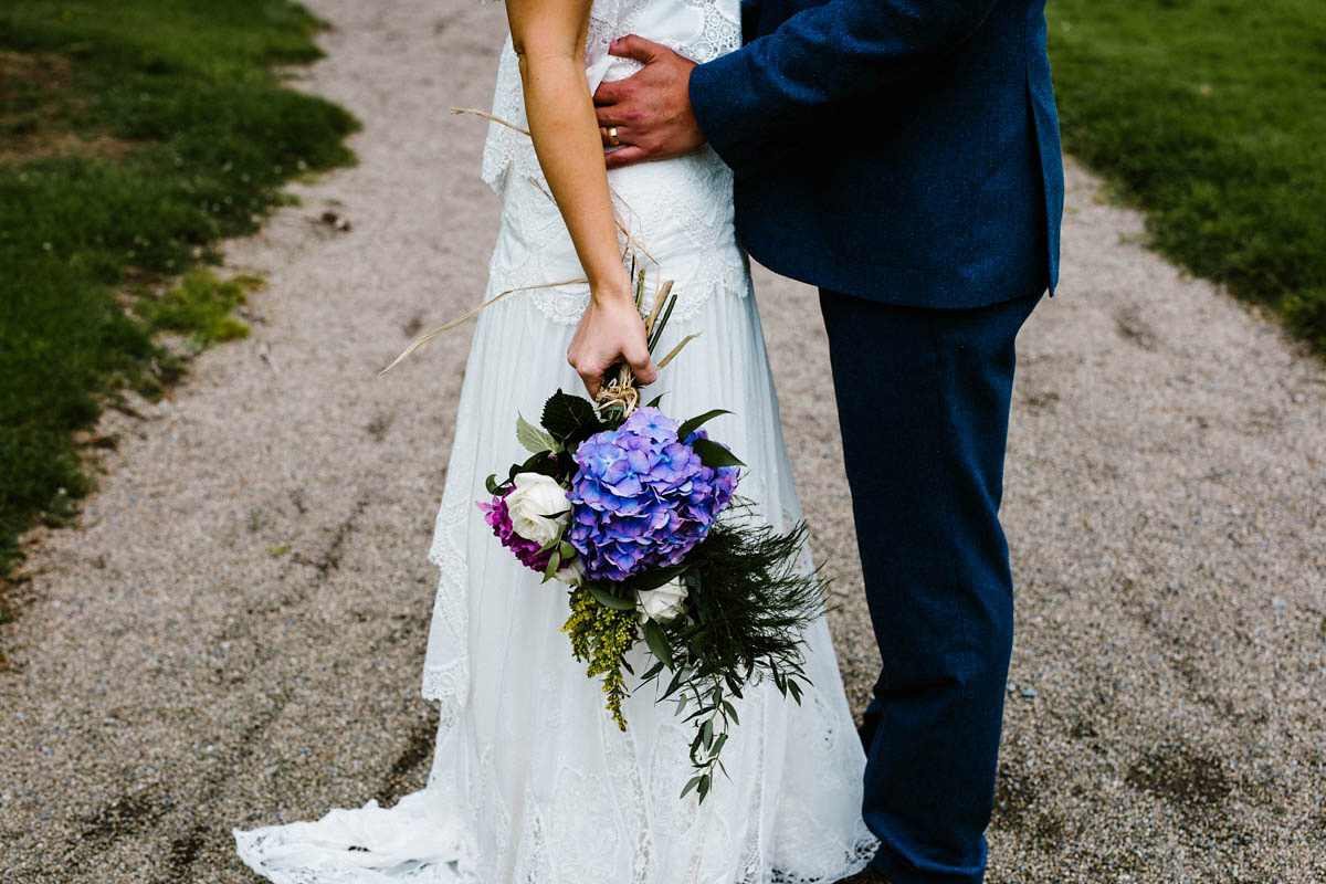 Kirsty wore a Rue de Seine gown from Leonie C. Bridal boutique in Brighton. Her handmade, Summer wedding took place in a Game of Thrones venue in Downpatrick. It was filled with floral chandeliers. Photography by Honey and the Moon.