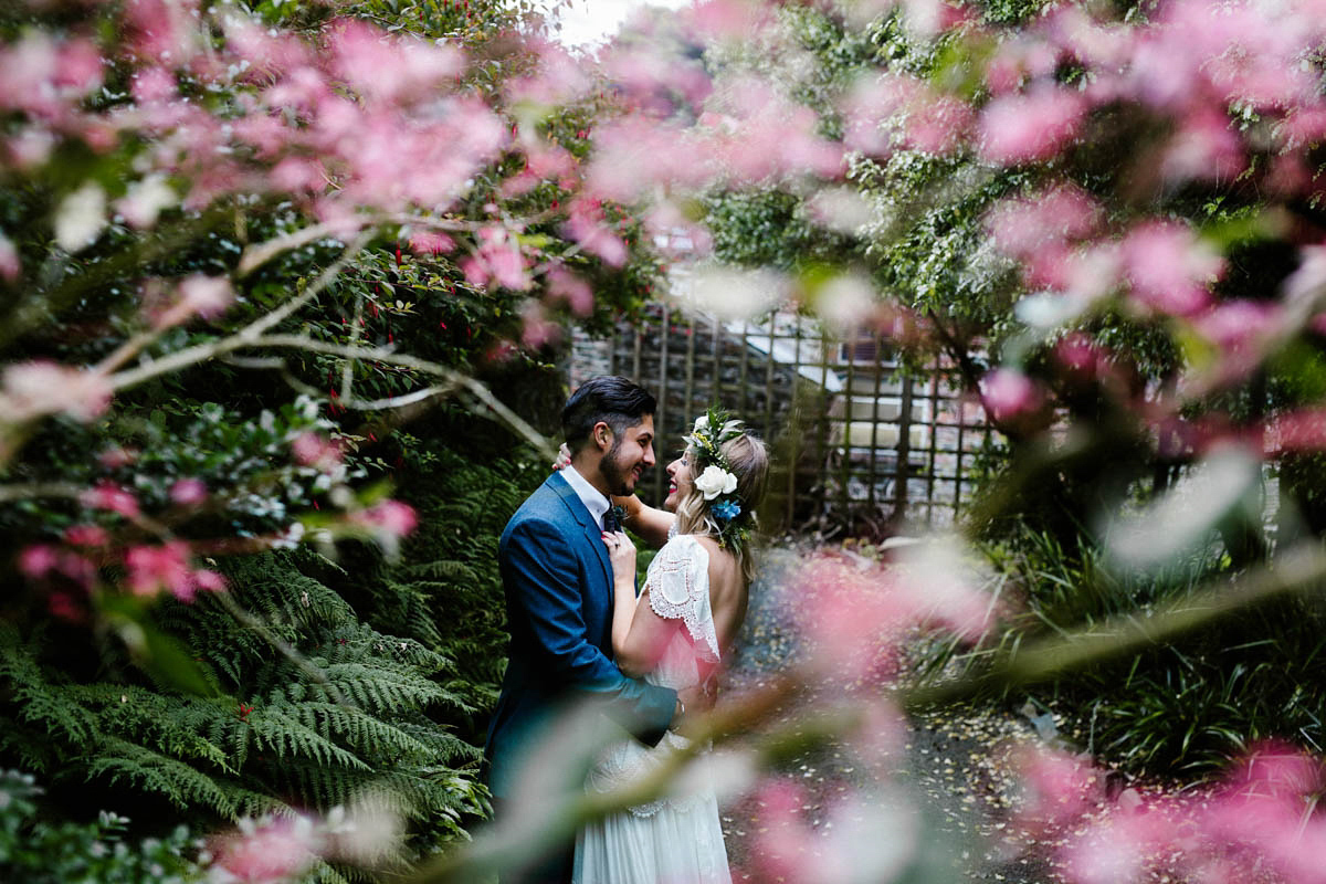 Kirsty wore a Rue de Seine gown from Leonie C. Bridal boutique in Brighton. Her handmade, Summer wedding took place in a Game of Thrones venue in Downpatrick. It was filled with floral chandeliers. Photography by Honey and the Moon.