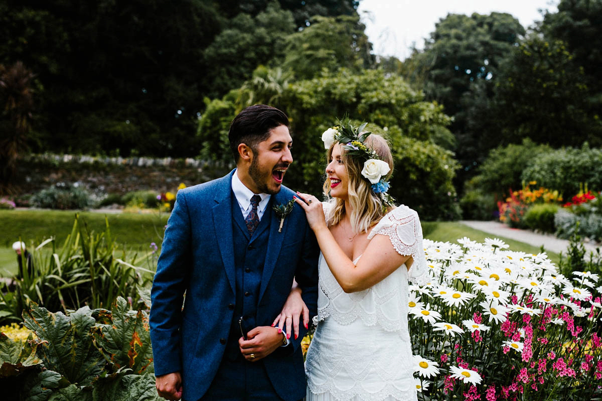 Kirsty wore a Rue de Seine gown from Leonie C. Bridal boutique in Brighton. Her handmade, Summer wedding took place in a Game of Thrones venue in Downpatrick. It was filled with floral chandeliers. Photography by Honey and the Moon.