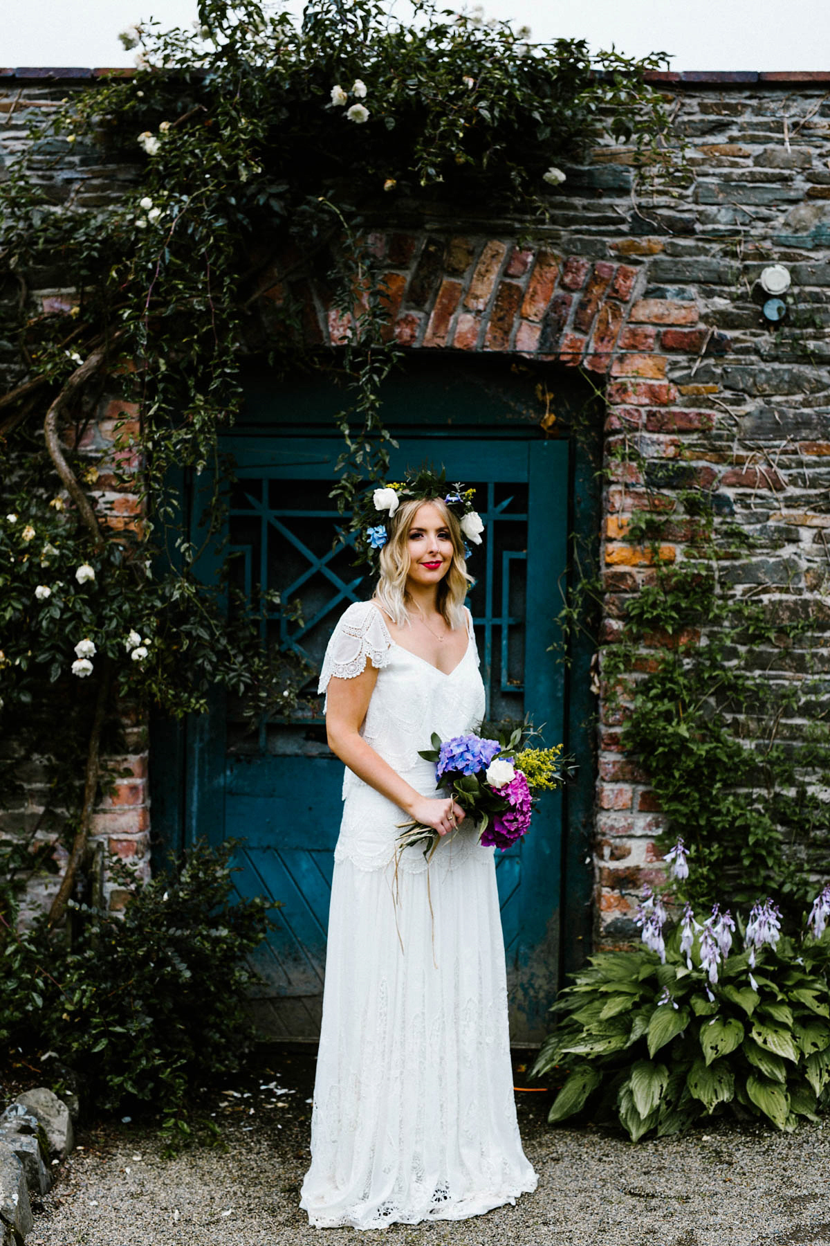 Kirsty wore a Rue de Seine gown from Leonie C. Bridal boutique in Brighton. Her handmade, Summer wedding took place in a Game of Thrones venue in Downpatrick. It was filled with floral chandeliers. Photography by Honey and the Moon.