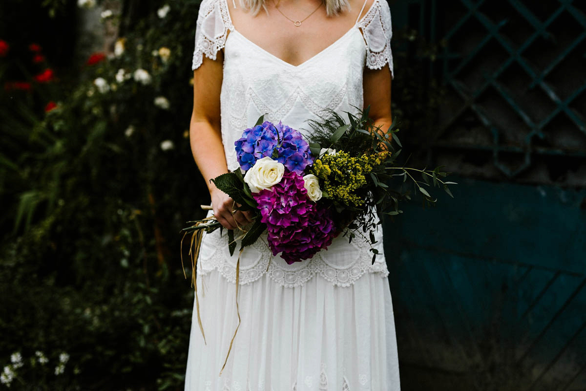 Kirsty wore a Rue de Seine gown from Leonie C. Bridal boutique in Brighton. Her handmade, Summer wedding took place in a Game of Thrones venue in Downpatrick. It was filled with floral chandeliers. Photography by Honey and the Moon.