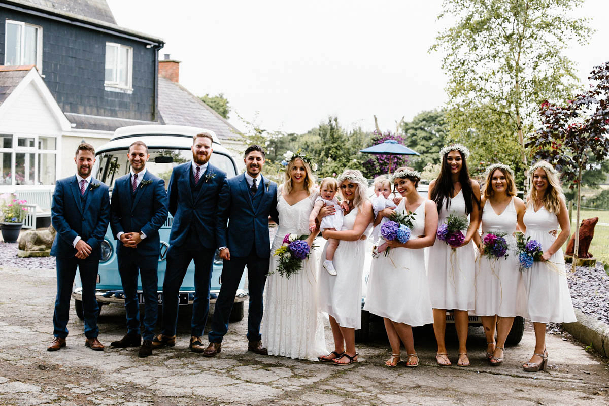 Kirsty wore a Rue de Seine gown from Leonie C. Bridal boutique in Brighton. Her handmade, Summer wedding took place in a Game of Thrones venue in Downpatrick. It was filled with floral chandeliers. Photography by Honey and the Moon.