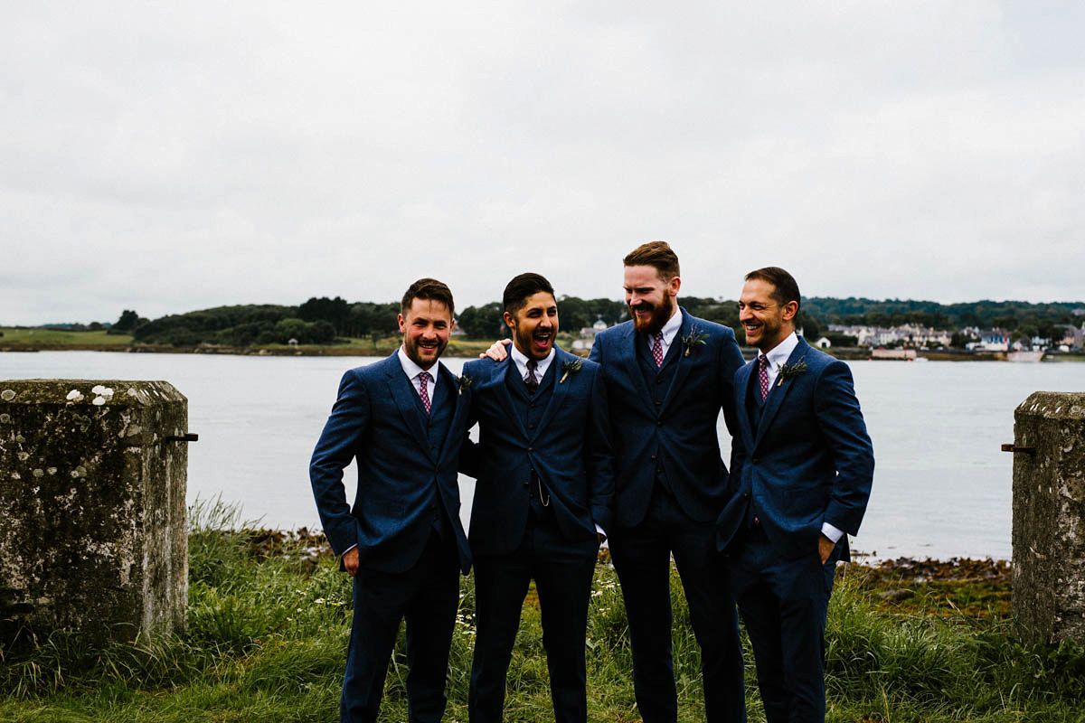 Kirsty wore a Rue de Seine gown from Leonie C. Bridal boutique in Brighton. Her handmade, Summer wedding took place in a Game of Thrones venue in Downpatrick. It was filled with floral chandeliers. Photography by Honey and the Moon.