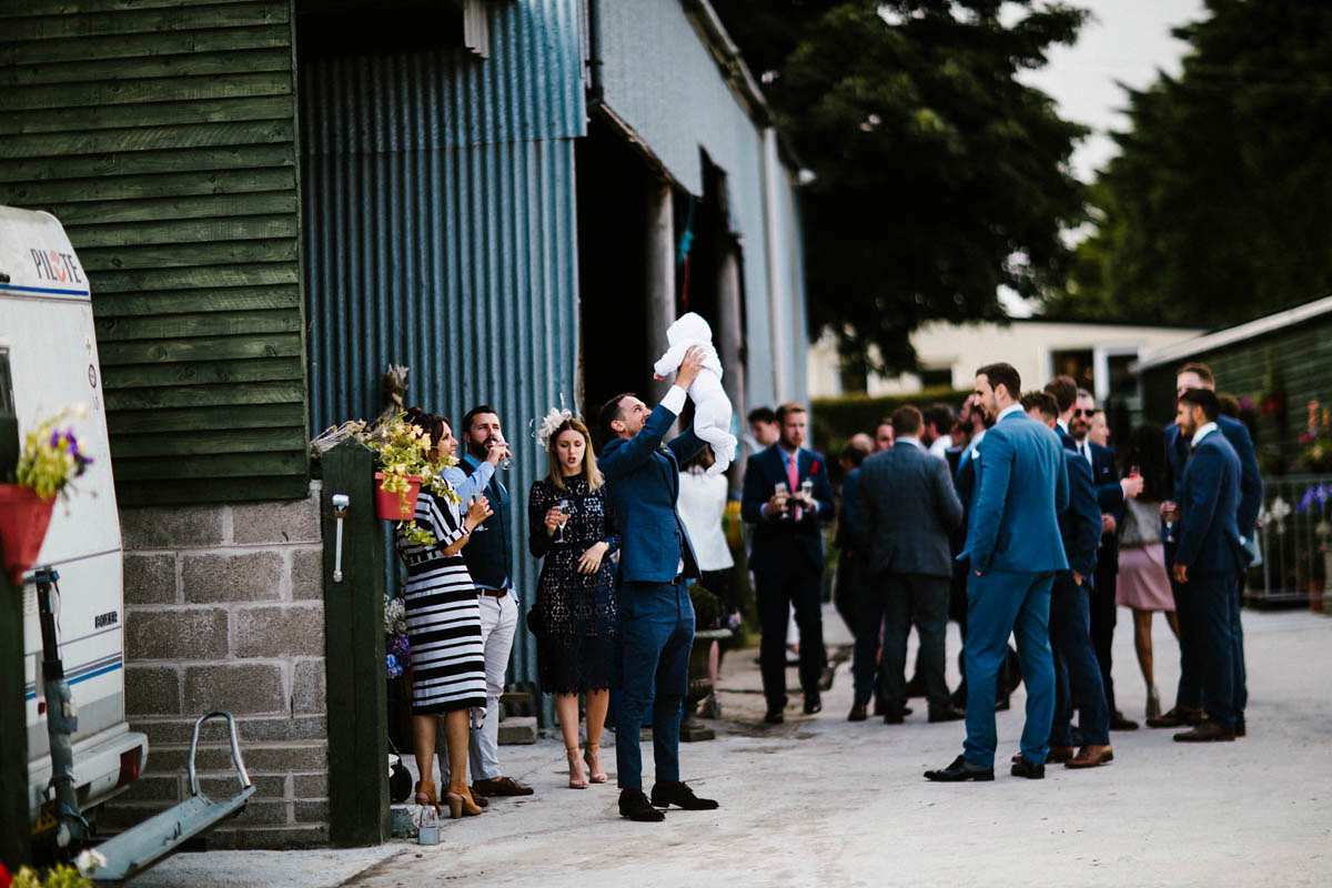 Kirsty wore a Rue de Seine gown from Leonie C. Bridal boutique in Brighton. Her handmade, Summer wedding took place in a Game of Thrones venue in Downpatrick. It was filled with floral chandeliers. Photography by Honey and the Moon.