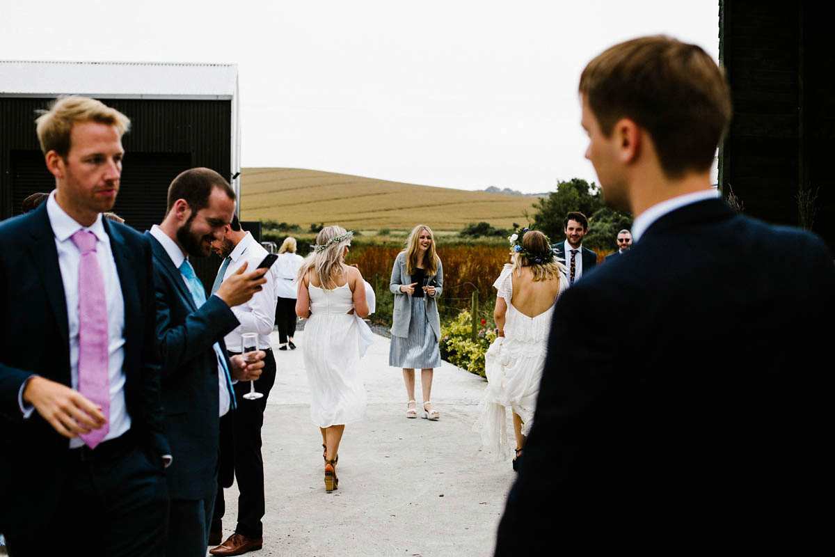 Kirsty wore a Rue de Seine gown from Leonie C. Bridal boutique in Brighton. Her handmade, Summer wedding took place in a Game of Thrones venue in Downpatrick. It was filled with floral chandeliers. Photography by Honey and the Moon.