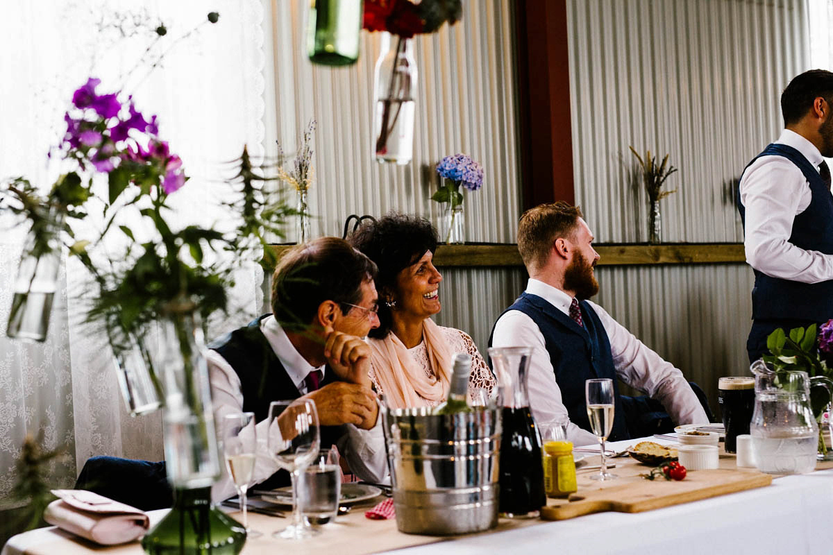 Kirsty wore a Rue de Seine gown from Leonie C. Bridal boutique in Brighton. Her handmade, Summer wedding took place in a Game of Thrones venue in Downpatrick. It was filled with floral chandeliers. Photography by Honey and the Moon.