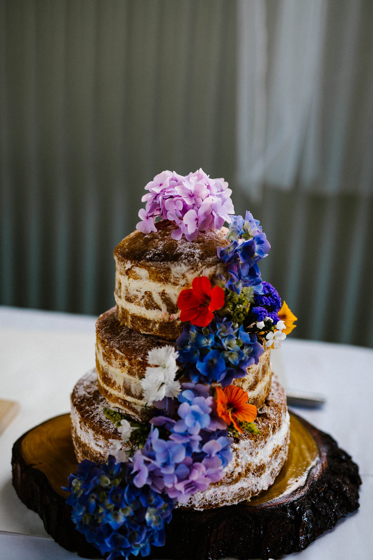 Kirsty wore a Rue de Seine gown from Leonie C. Bridal boutique in Brighton. Her handmade, Summer wedding took place in a Game of Thrones venue in Downpatrick. It was filled with floral chandeliers. Photography by Honey and the Moon.