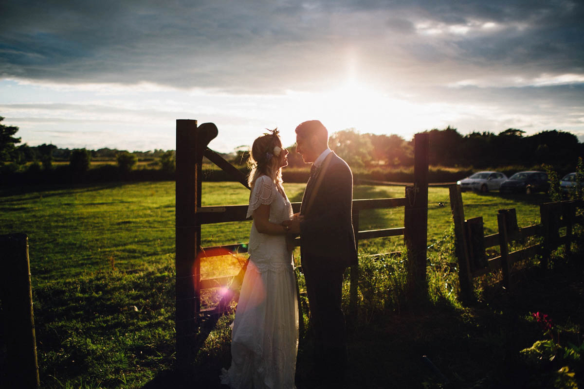 Kirsty wore a Rue de Seine gown from Leonie C. Bridal boutique in Brighton. Her handmade, Summer wedding took place in a Game of Thrones venue in Downpatrick. It was filled with floral chandeliers. Photography by Honey and the Moon.