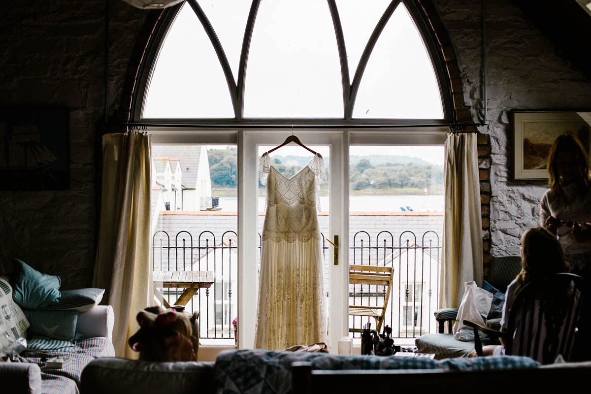 Kirsty wore a Rue de Seine gown from Leonie C. Bridal boutique in Brighton. Her handmade, Summer wedding took place in a Game of Thrones venue in Downpatrick. It was filled with floral chandeliers. Photography by Honey and the Moon.